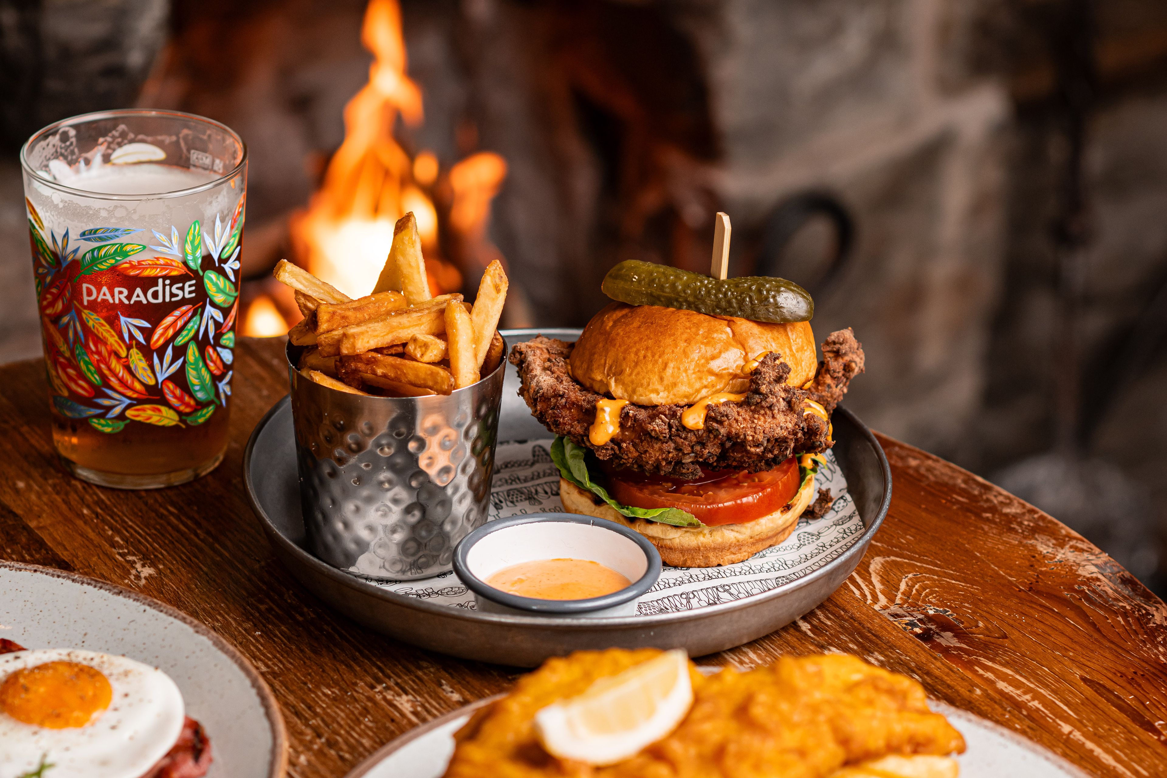 chicken burger with a thwaites ale by the fire